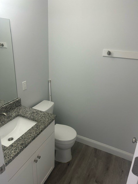 75 Wharf Street, Unit 202 Salem, MA 01970 - Photo 5 of 13 a bathroom with a granite countertop sink toilet and a mirror
