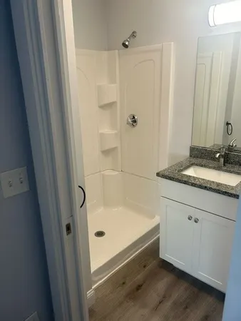a bathroom with a tub sink and mirror