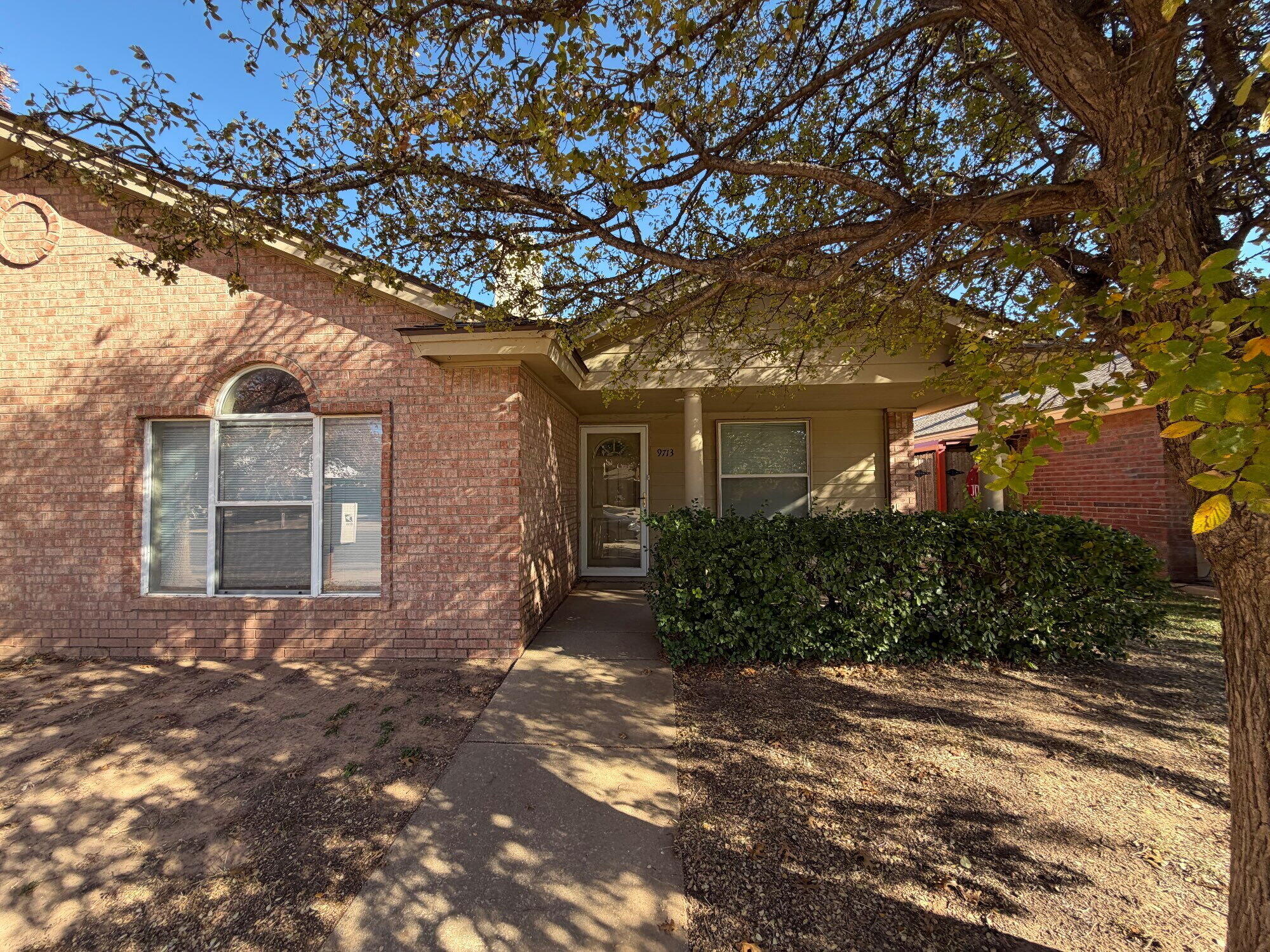 9713 Joliet Avenue Lubbock, TX 79423 - Photo 1 of 11 a front view of a house with a yard