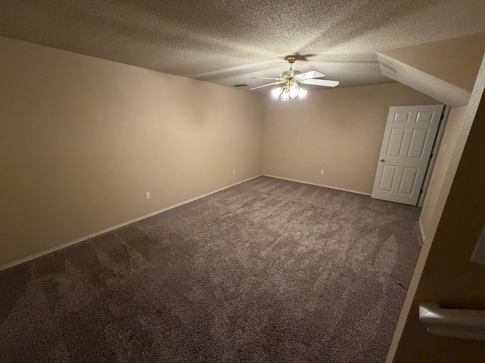 9713 Joliet Avenue Lubbock, TX 79423 - Photo 11 of 11 a view of an empty room with a chandelier fan