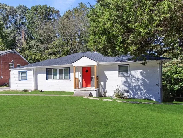a front view of house with yard and green space