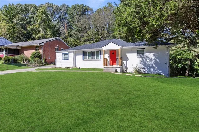 a front view of a house with a garden