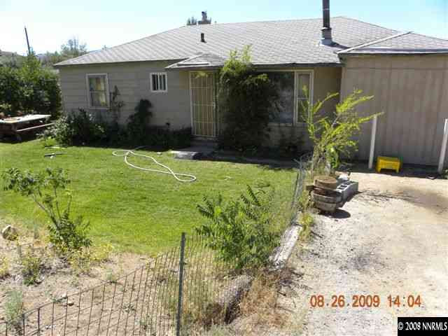8945 Reservoir Street Reno, NV 89506 - Photo 1 of 2 a front view of a house with garden