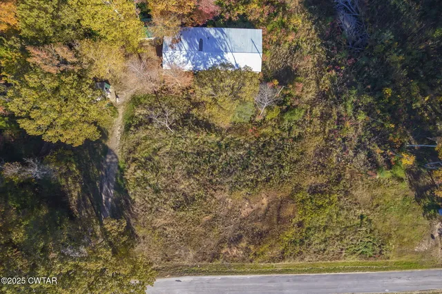 an aerial view of residential houses with outdoor space and river