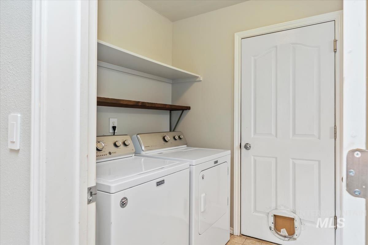 80 Cobblestone Court Middleton, ID 83644 - Photo 16 of 48 Laundry area featuring a built-in white shelf and a wood-finish floating shelf