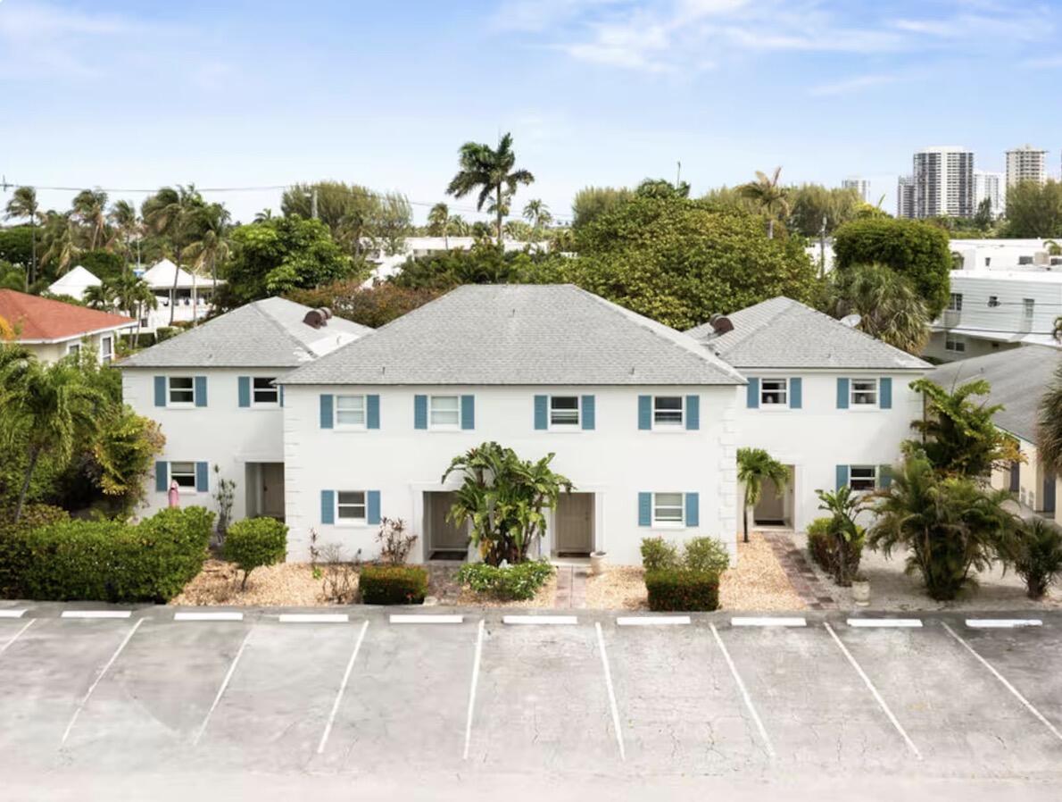 1216 Surf Road Singer Island, FL 33404 - Photo 1 of 15 a front view of a house with garden