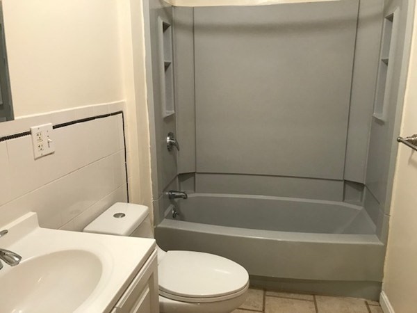141 Jefferson Avenue, Unit 2 Everett, MA 02149 - Photo 5 of 10 a white bath tub sitting next to a toilet