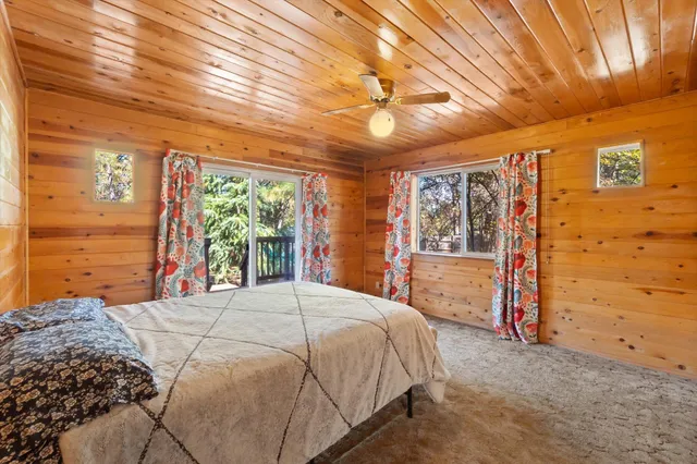 a bed sitting in a spacious bedroom next to a window