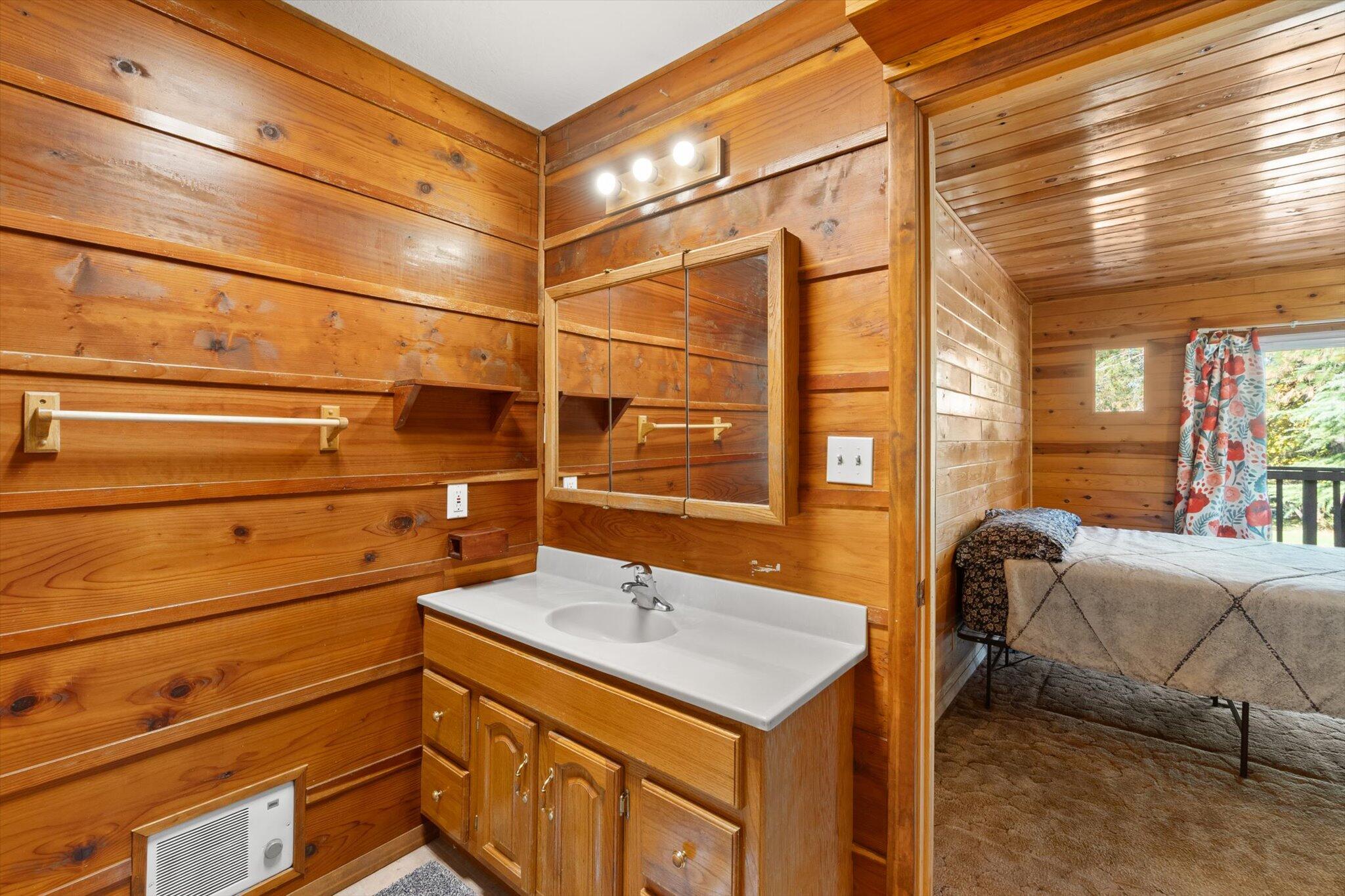 28449 Whippoorwill Circle Shingletown, CA 96088 - Photo 15 of 52 a bathroom with a sink and a mirror