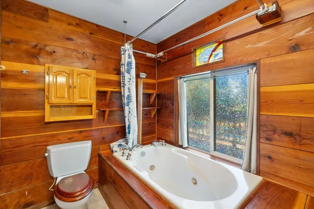 a white bath tub sitting next to a white toilet