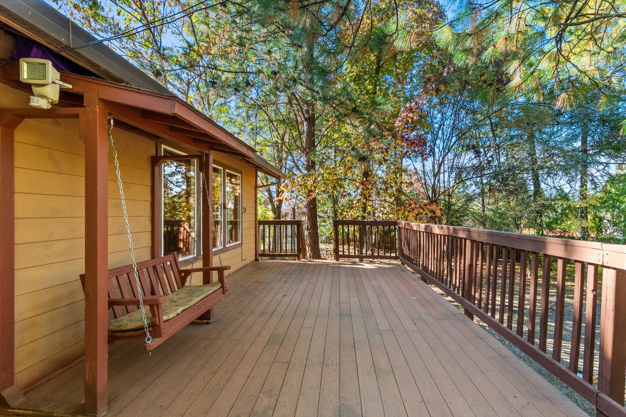 28449 Whippoorwill Circle Shingletown, CA 96088 - Photo 26 of 52 a view of a porch with wooden floor and fence