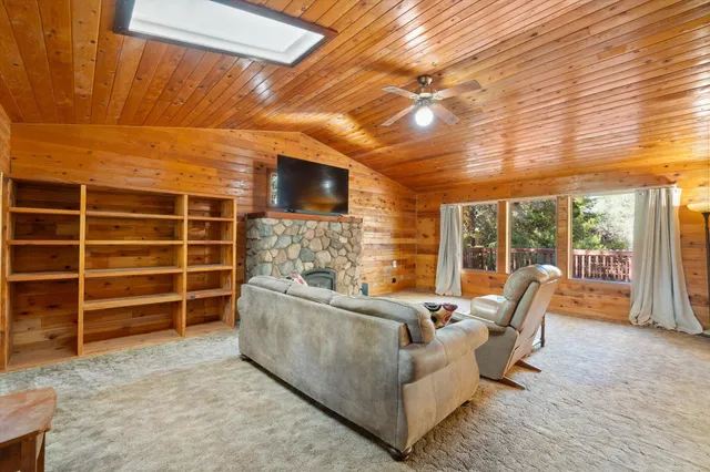 a living room with furniture windows and a flat screen tv