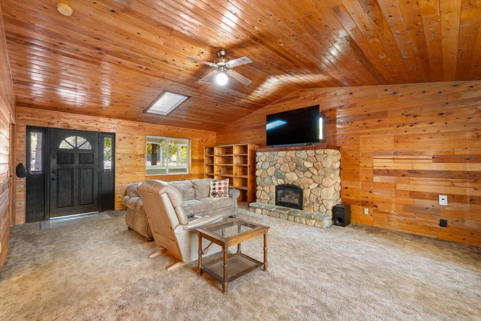 28449 Whippoorwill Circle Shingletown, CA 96088 - Photo 5 of 52 a living room with furniture a flat screen tv and a fireplace