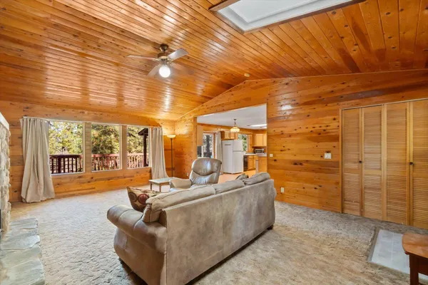 a living room with patio furniture and a large window