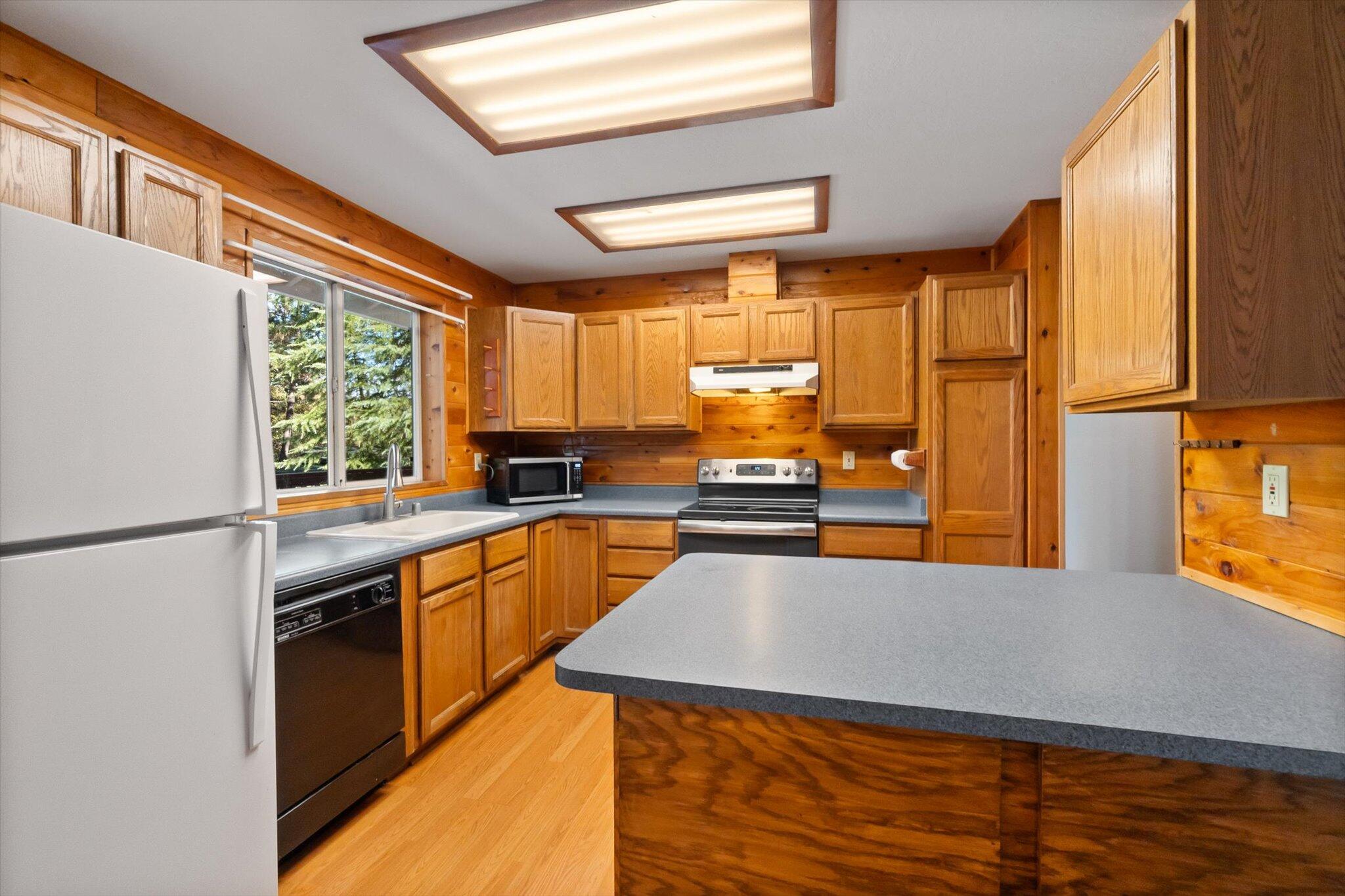 28449 Whippoorwill Circle Shingletown, CA 96088 - Photo 10 of 52 a kitchen with stainless steel appliances a refrigerator sink and cabinets