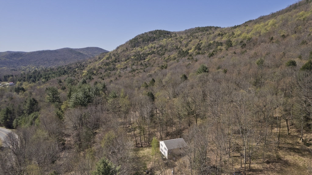 300 Middlefield Road Chester, MA 01011 - Photo 13 of 40 a view of a large mountain with mountains in the background