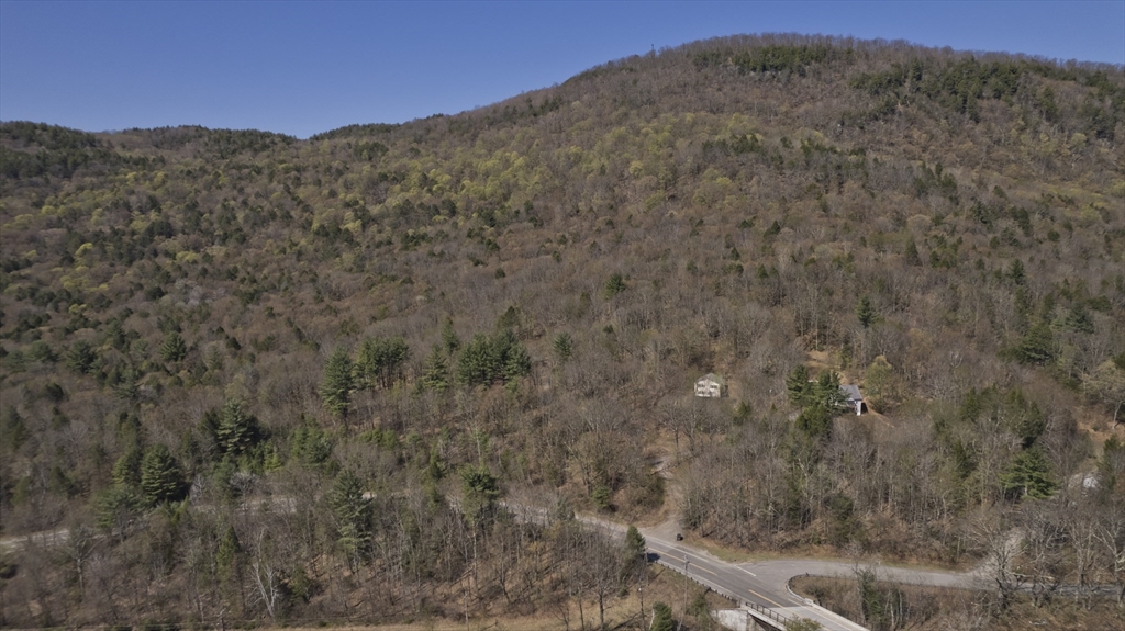 300 Middlefield Road Chester, MA 01011 - Photo 15 of 40 a view of a dry yard with mountains in the background