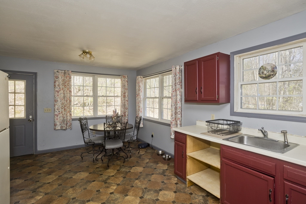 300 Middlefield Road Chester, MA 01011 - Photo 19 of 40 a kitchen with a dining table chairs and large window