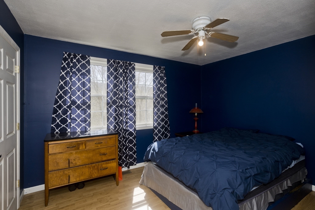 300 Middlefield Road Chester, MA 01011 - Photo 30 of 40 a bedroom with a bed and a ceiling fan