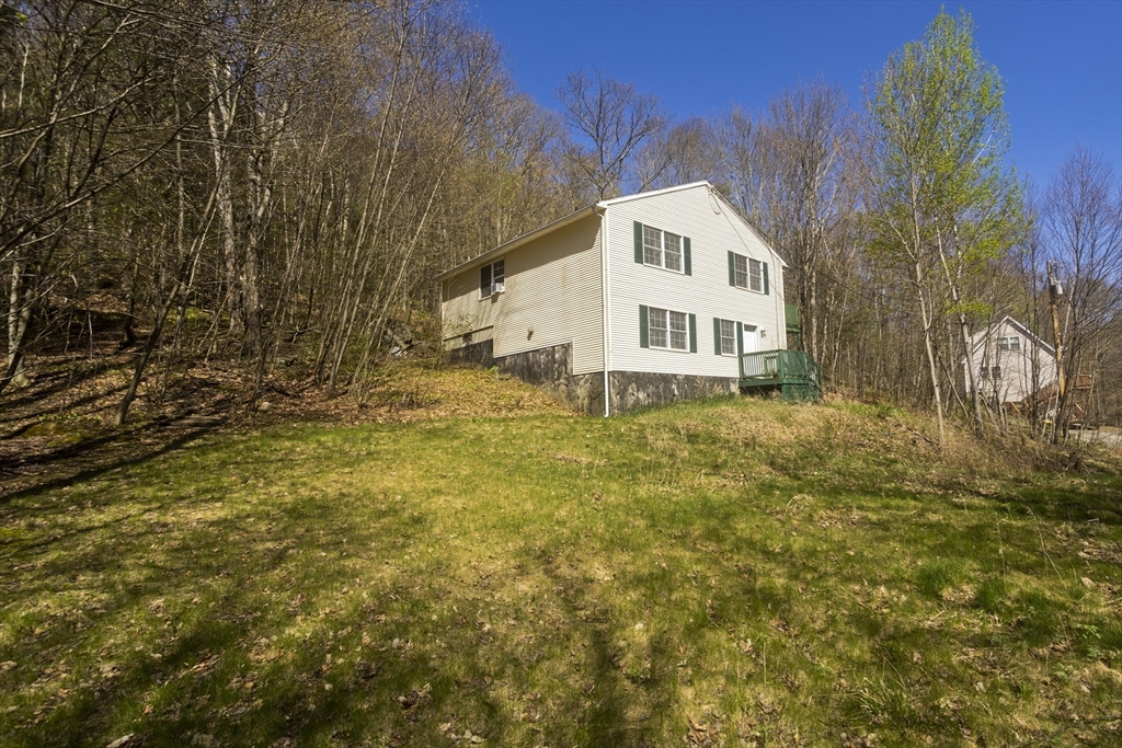 300 Middlefield Road Chester, MA 01011 - Photo 3 of 40 a front view of a house with a yard