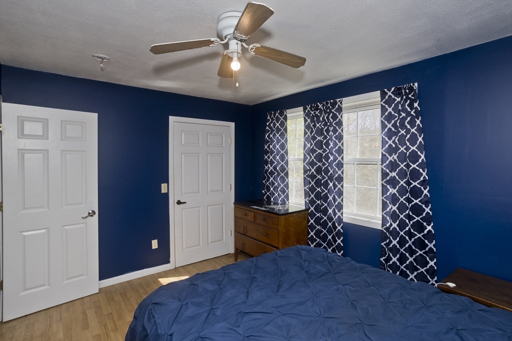 300 Middlefield Road Chester, MA 01011 - Photo 31 of 40 a bedroom with a bed and a chandelier