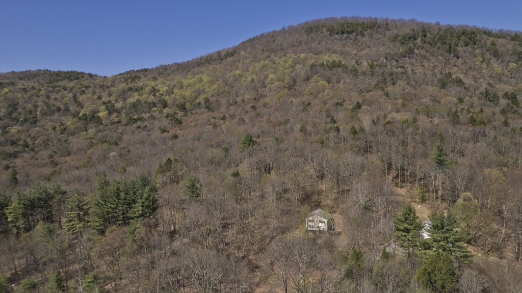 300 Middlefield Road Chester, MA 01011 - Photo 10 of 40 a view of a dry yard with mountains in the background