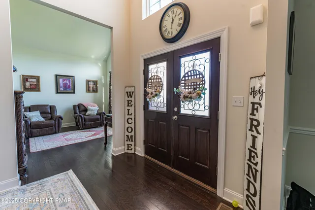 a living room with furniture a rug and a large window