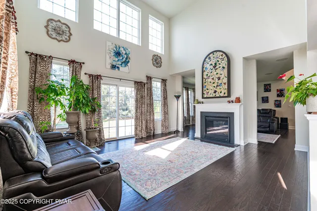 a kitchen with stainless steel appliances granite countertop a refrigerator a stove and a wooden floors