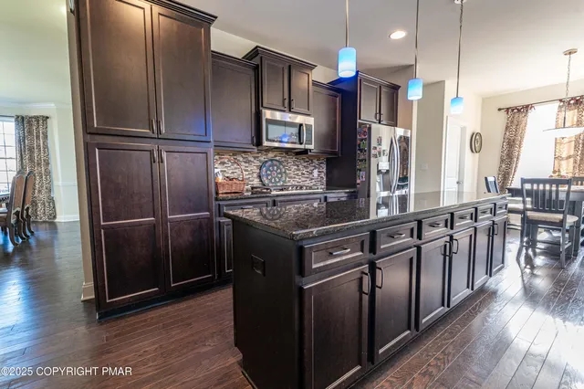 a bedroom with a bed dresser and a window