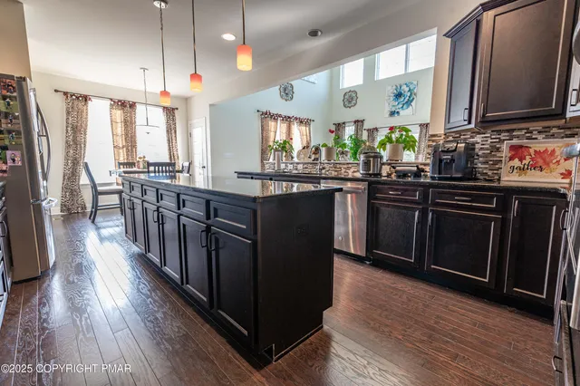 a living room with furniture and a ceiling fan