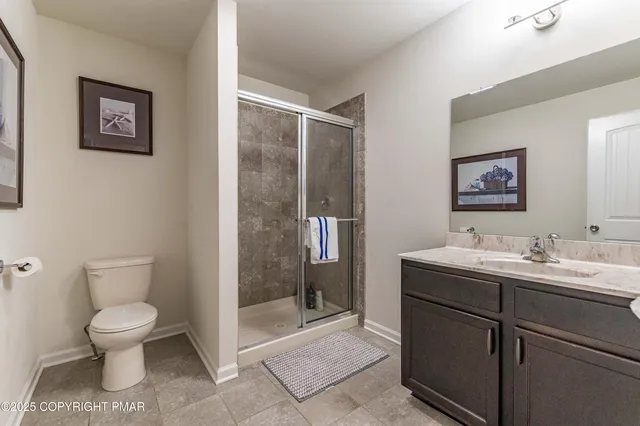 an aerial view of residential houses with outdoor space and trees