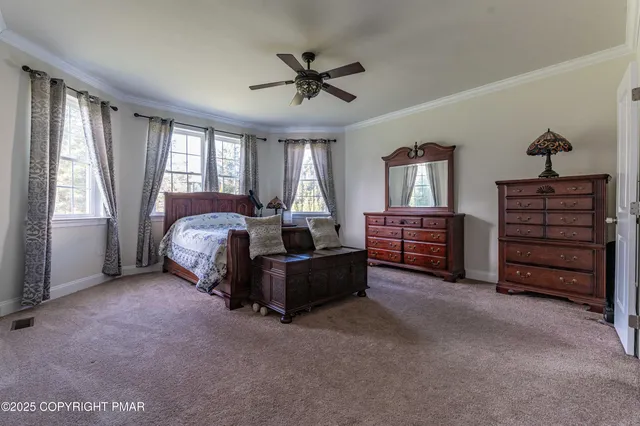 a view of a hallway with wooden floor windows and a bathroom