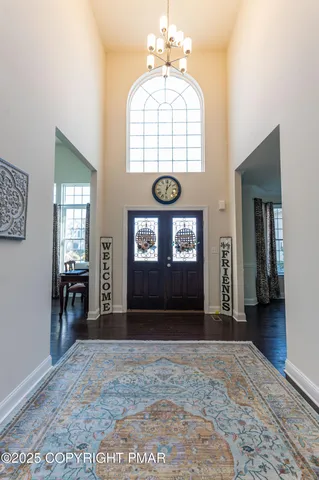 a view of a hallway with wooden floor and a window
