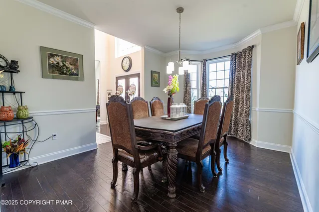a view of a hallway with wooden floor and a large window