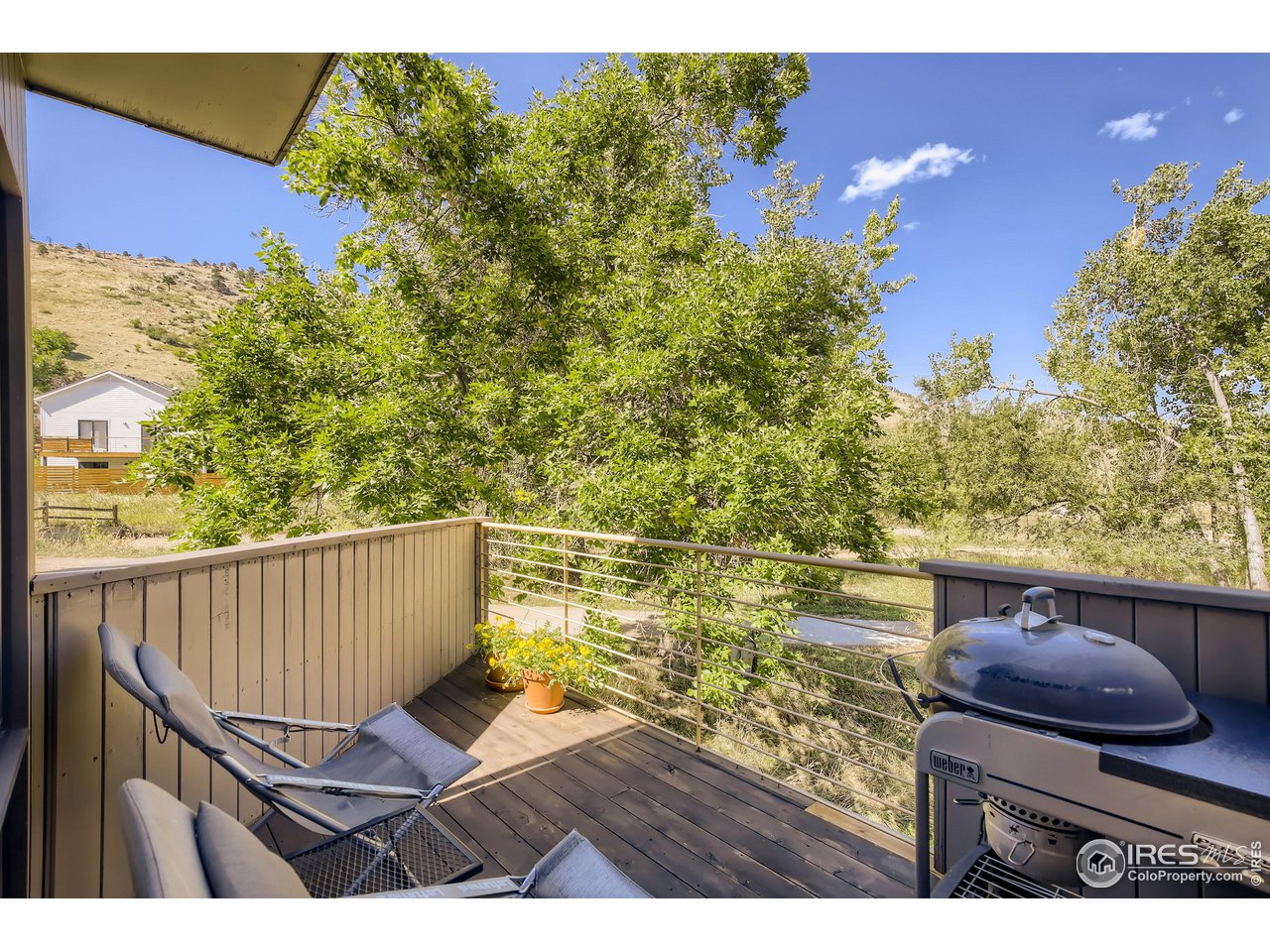 365 Quail Circle Boulder, CO 80304 - Photo 15 of 29 a view of a balcony with chair and wooden floor
