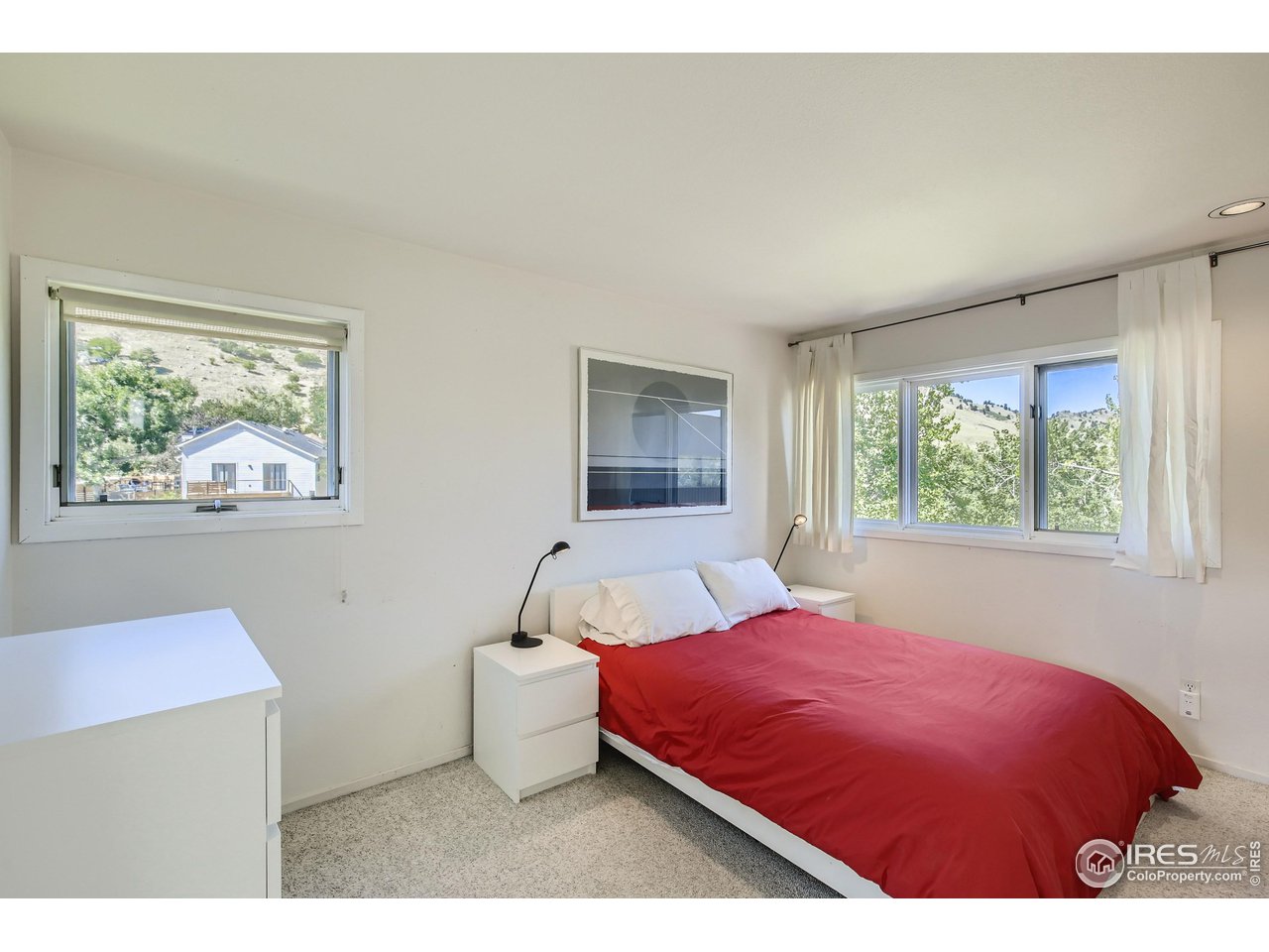 365 Quail Circle Boulder, CO 80304 - Photo 16 of 29 a bedroom with a bed and a painting on the wall