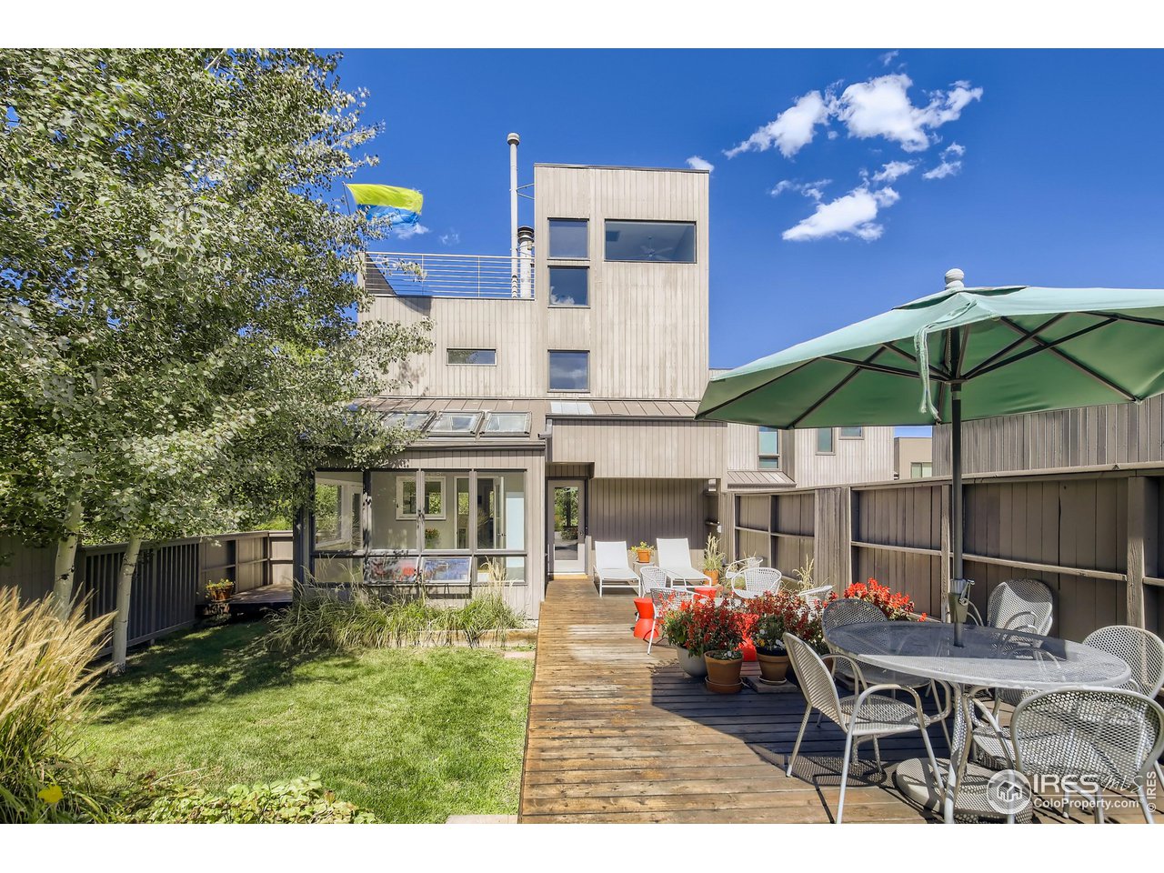 365 Quail Circle Boulder, CO 80304 - Photo 2 of 29 a view of a patio with couches table and chairs under an umbrella