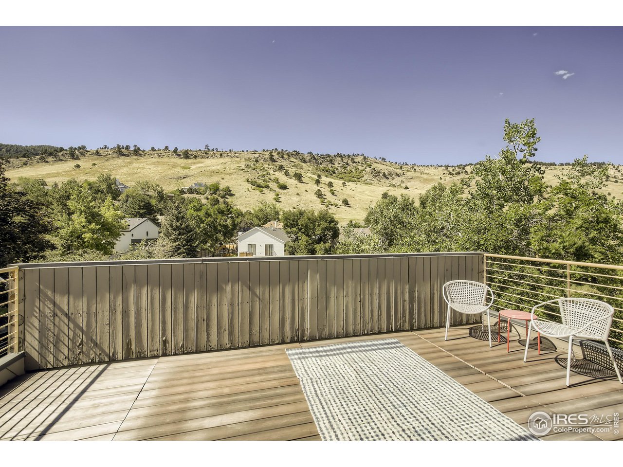 365 Quail Circle Boulder, CO 80304 - Photo 26 of 29 a view of a balcony with chair and wooden floor