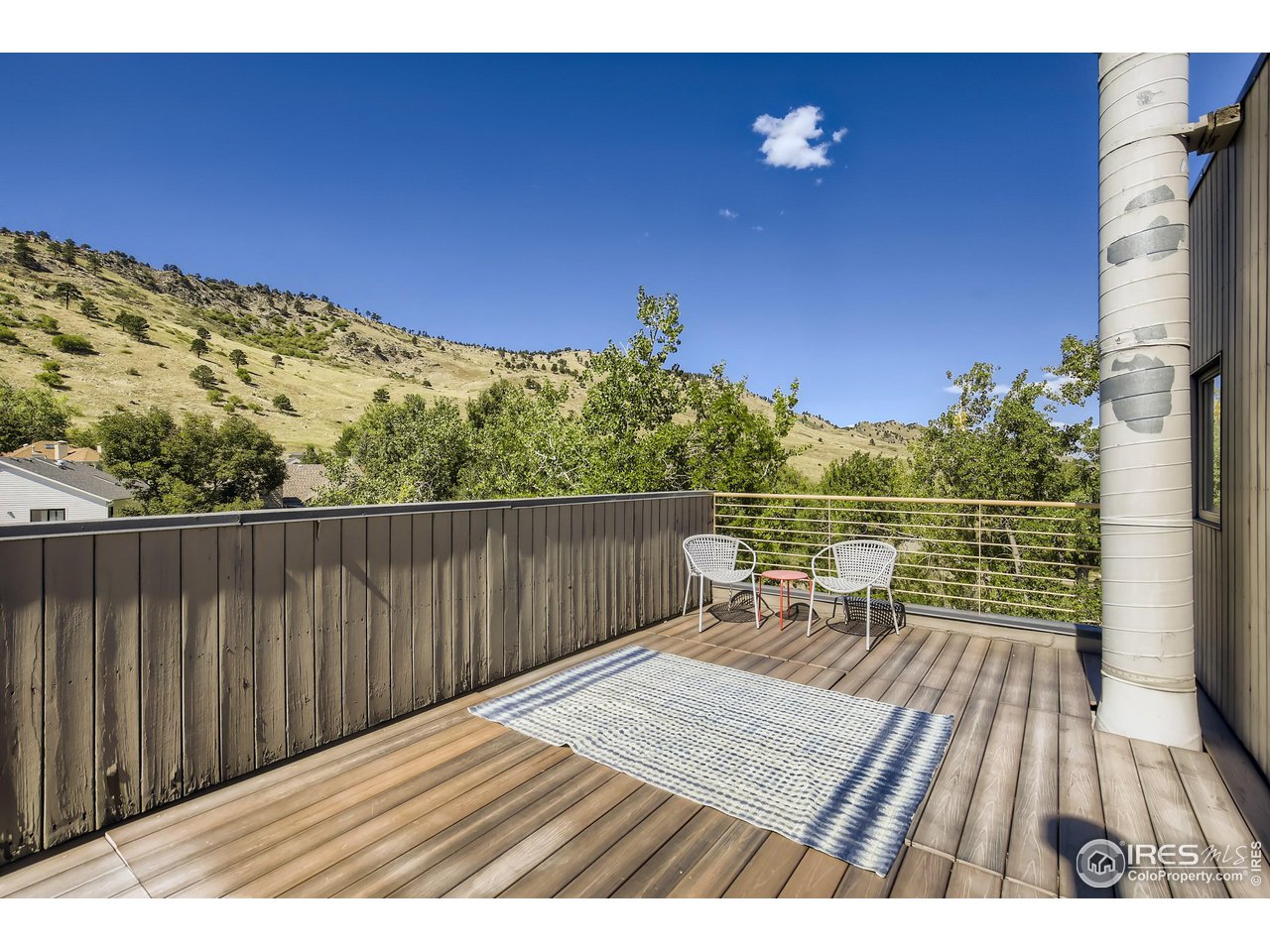 365 Quail Circle Boulder, CO 80304 - Photo 27 of 29 a view of a roof deck with table and chairs a barbeque with wooden floor