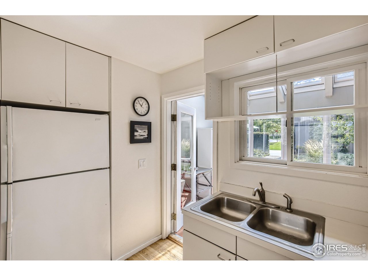 365 Quail Circle Boulder, CO 80304 - Photo 8 of 29 a kitchen with a refrigerator a sink and cabinets