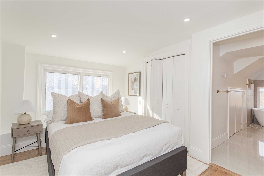 125 Mt Vernon Street, Unit 2 Newton, MA 02465 - Photo 31 of 36 a bedroom with a bed and a view of bathroom