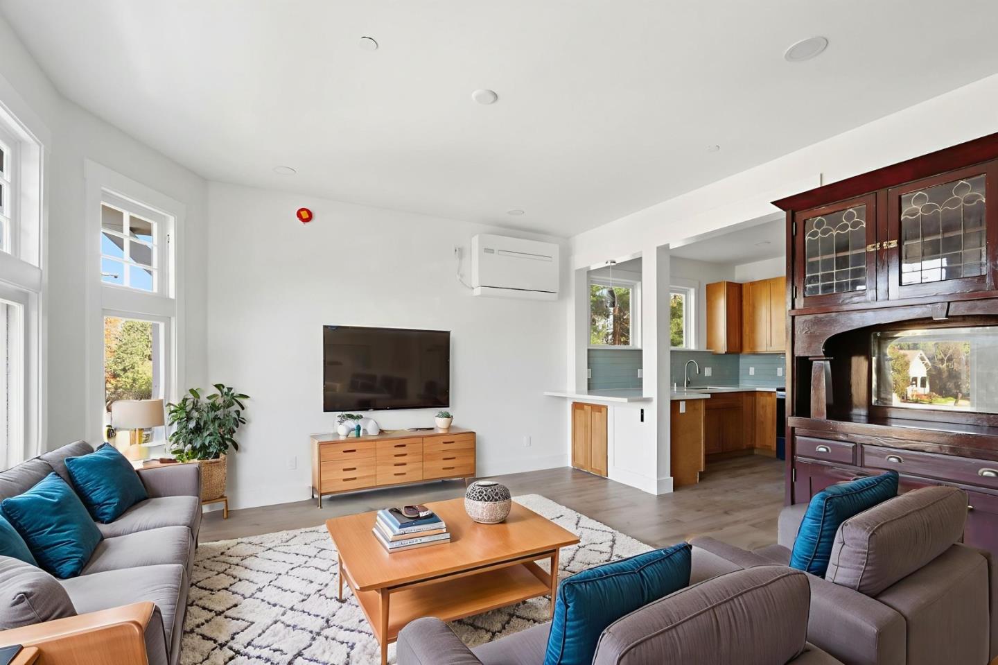 140 East Reed Street, Unit 3 San Jose, CA 95112 - Photo 1 of 8 a living room with furniture and a flat screen tv