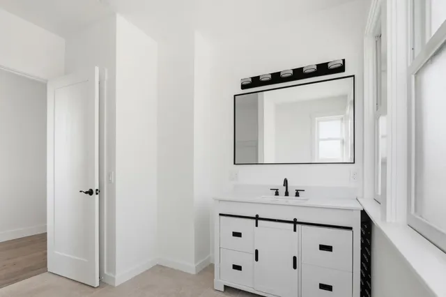 a bathroom with a double vanity sink and mirror