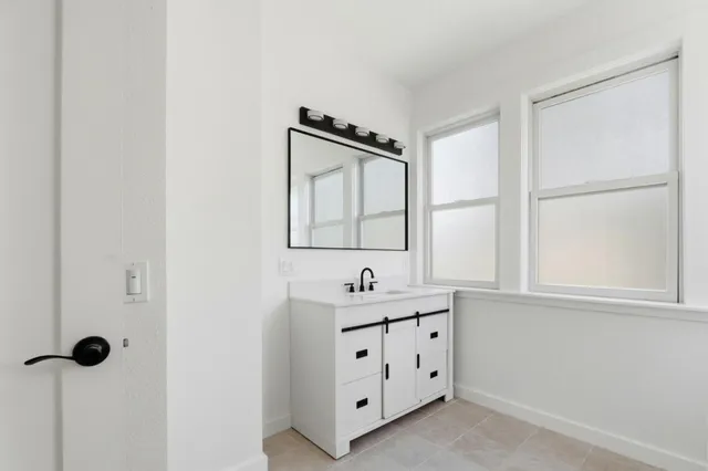 a bathroom with a granite countertop sink mirror and a