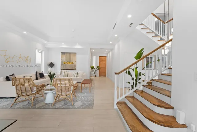 a dining room with furniture and a rug