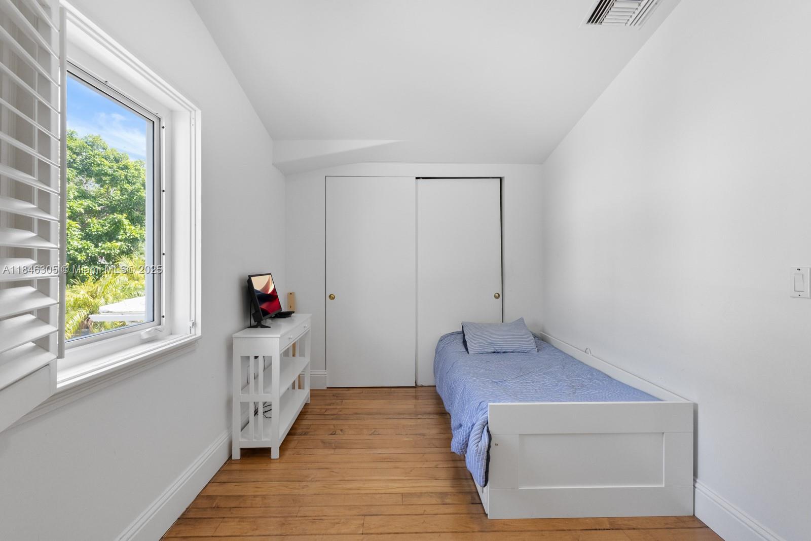 5 Coconut Lane Key Biscayne, FL 33149 - Photo 14 of 41 a hallway with wooden floor and windows