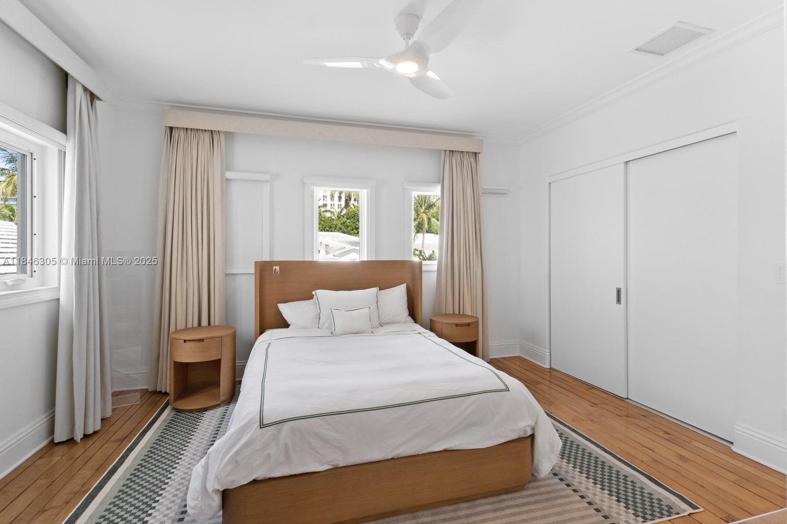 5 Coconut Lane Key Biscayne, FL 33149 - Photo 17 of 41 a bedroom with a bed and wooden floor