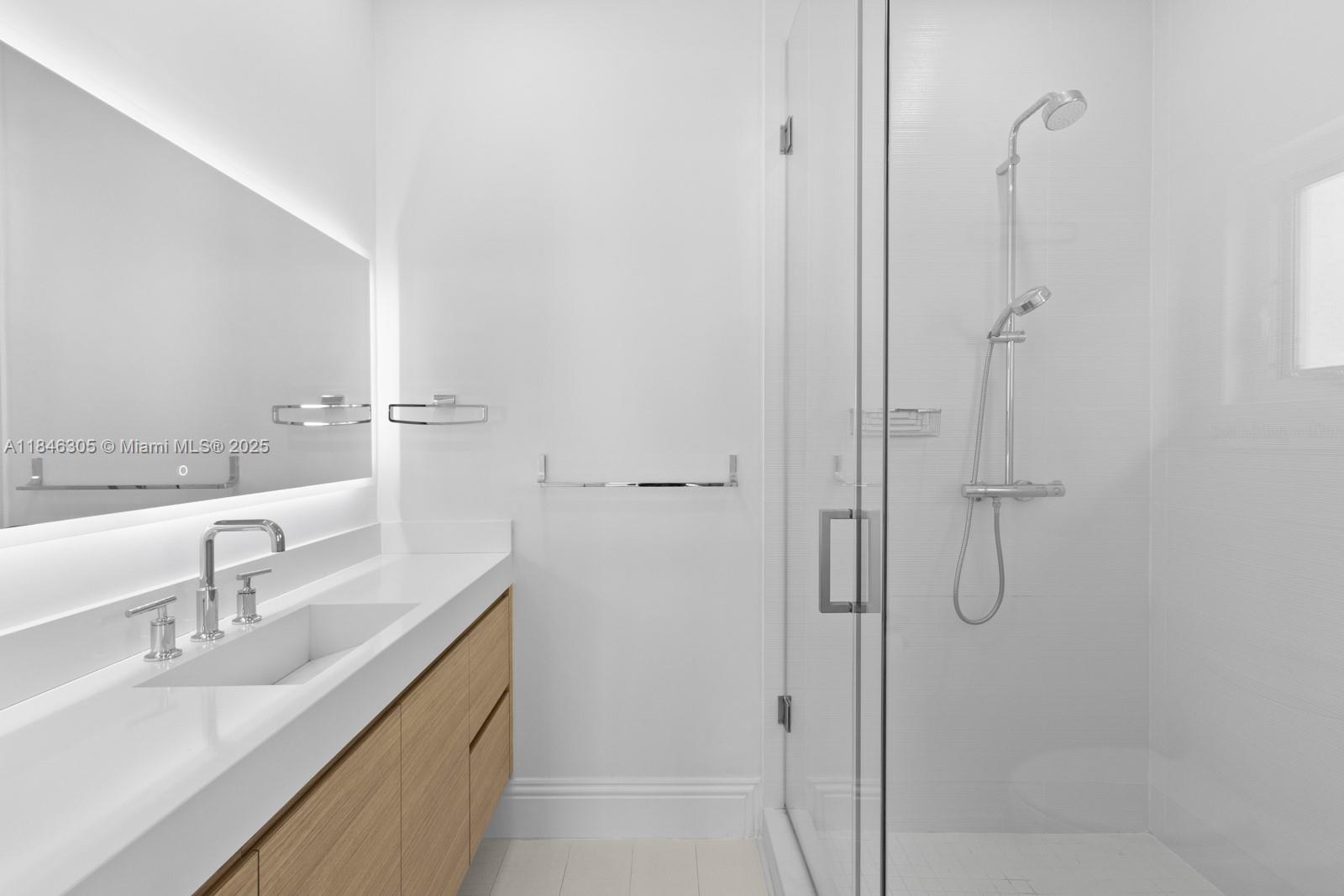 5 Coconut Lane Key Biscayne, FL 33149 - Photo 19 of 41 a bathroom with a double vanity sink mirror and shower