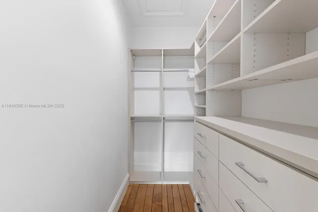 a view of walk in closet with empty racks