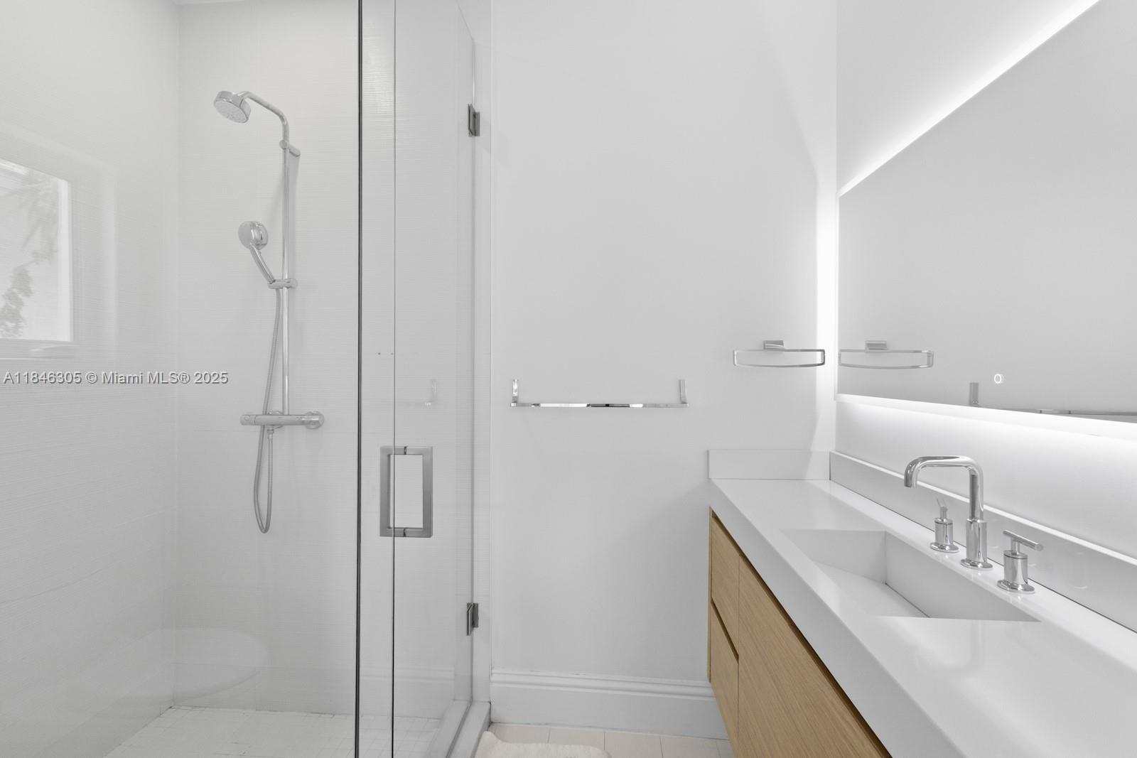 5 Coconut Lane Key Biscayne, FL 33149 - Photo 23 of 41 a bathroom with a granite countertop shower sink and mirror